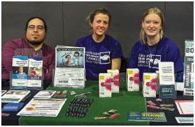 photo of Outreach and Education specialists Rachel Larson and Brooke Cowden offering information and a range of Health District services along with Roy Ramirez, prescription assistance and health coverage specialist